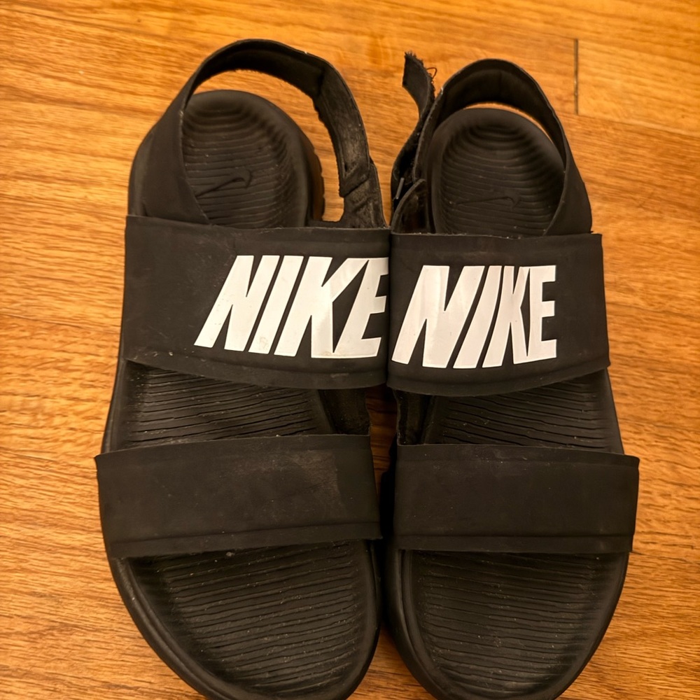 Nike Women's Tanjun sandals featuring the bold logo across the front strap